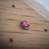 Pink cubic zirconia attachment in titanium bezelset