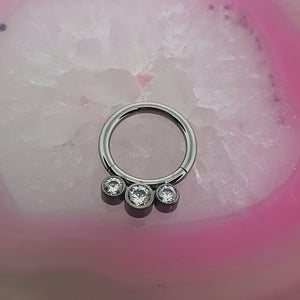 Hinged clicker with cubic zirconia