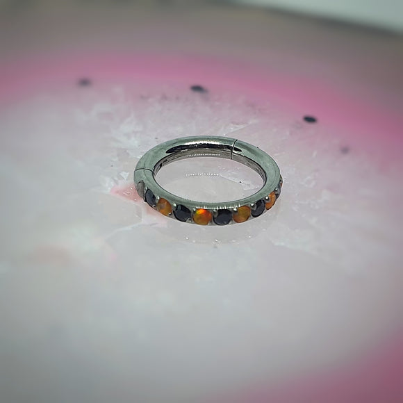 Frontfacing hinged ring with black and orange zirconia