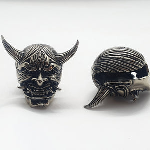 jewelry for stretched earlobes in the form of a hannya mask with two sets of tusks made out of brass