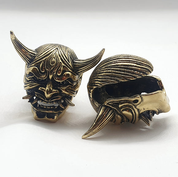 jewelry for stretched earlobes in the form of a hannya mask with two sets of tusks made out of brass