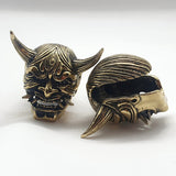 jewelry for stretched earlobes in the form of a hannya mask with two sets of tusks made out of brass